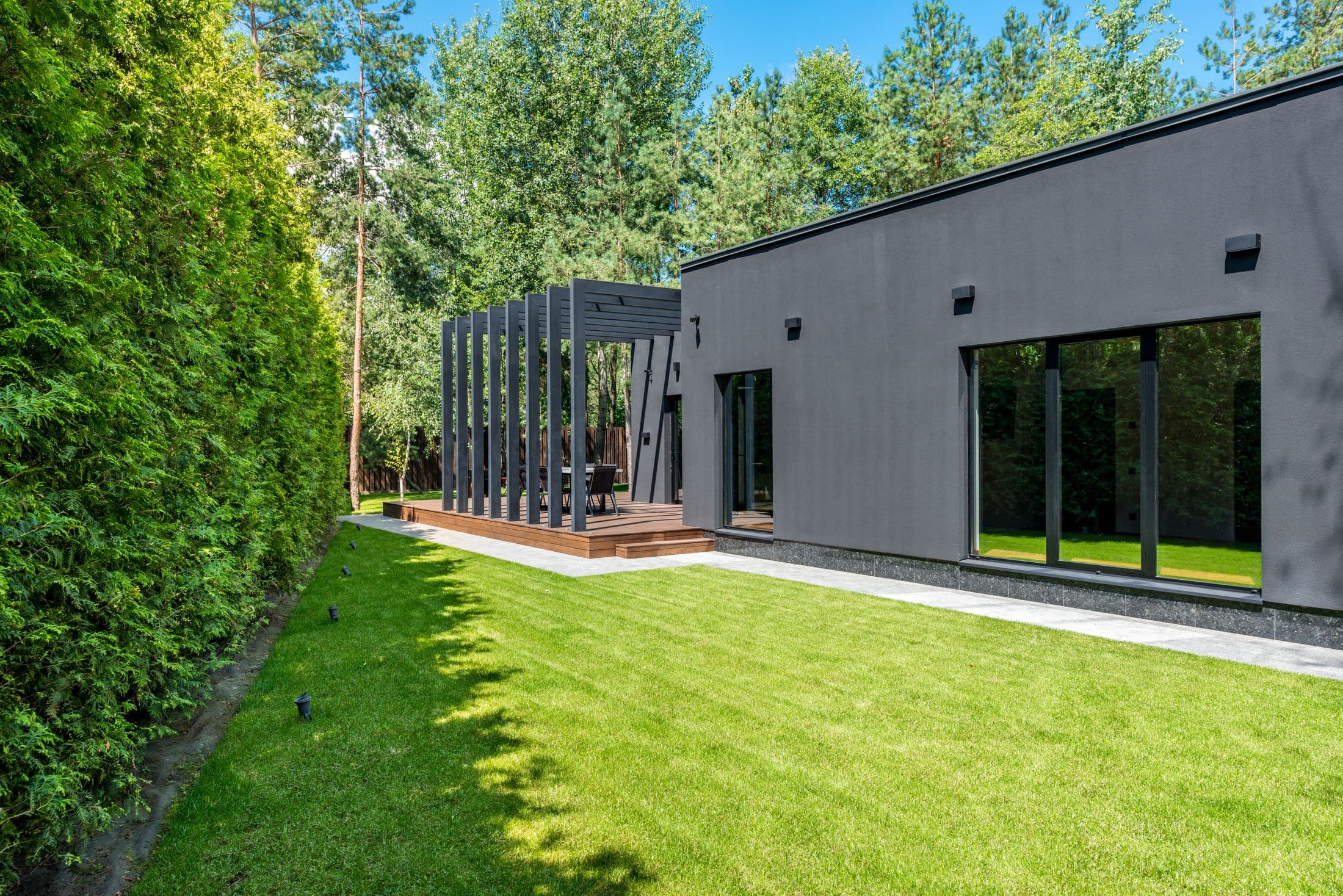 Well-kept home and lawn surrounded by trees